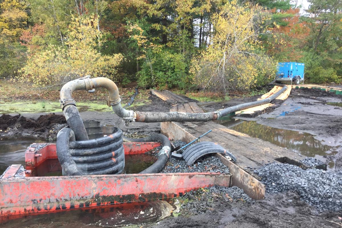 Dewatering pump in middle of pond